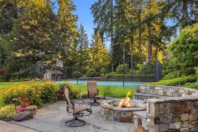 Outdoor entertaining with Pickleball court and cozy fireplace