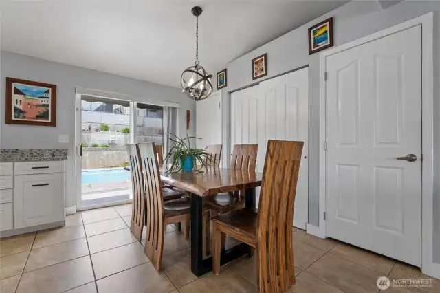 Dining space and kitchen with walk-out to backyard oasis