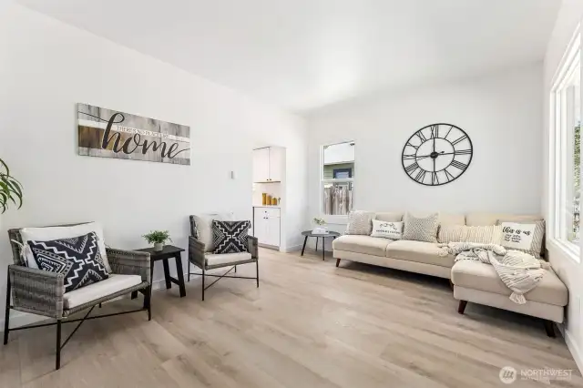 Bright and stylish living space featuring fresh paint and easy-care LVP flooring throughout.