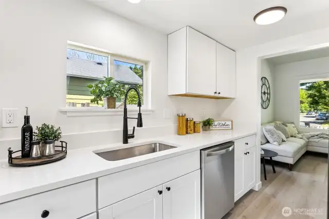 Sleek, modern kitchen with brand new stainless steel appliances, quartz countertops & all-new cabinetry.