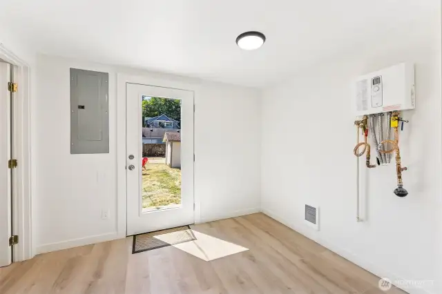 Light-filled utility room with direct access to the oversized, fully fenced backyard—perfect for indoor-outdoor functionality.
