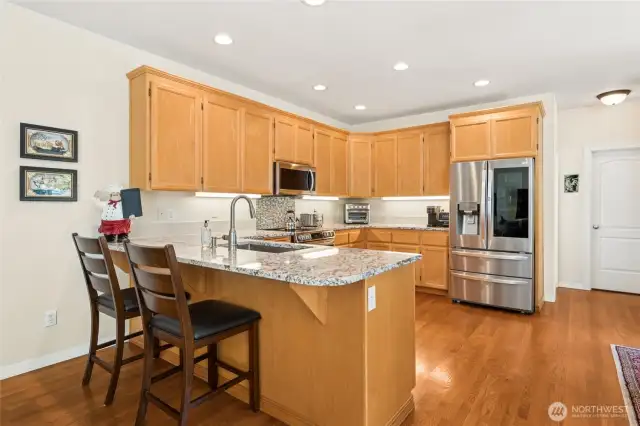 Stylish, spacious kitchen featuring granite countertops and newer stainless appliances.