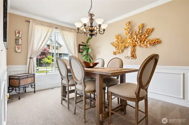 Gracious formal dining room features classic wainscoting and elegant crown molding.