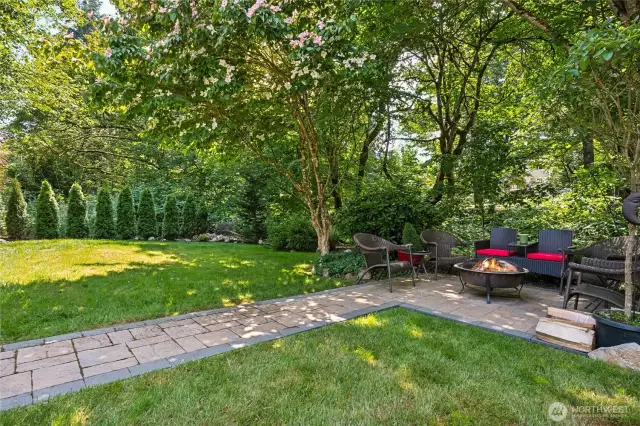 A lower patio set beneath the trees.