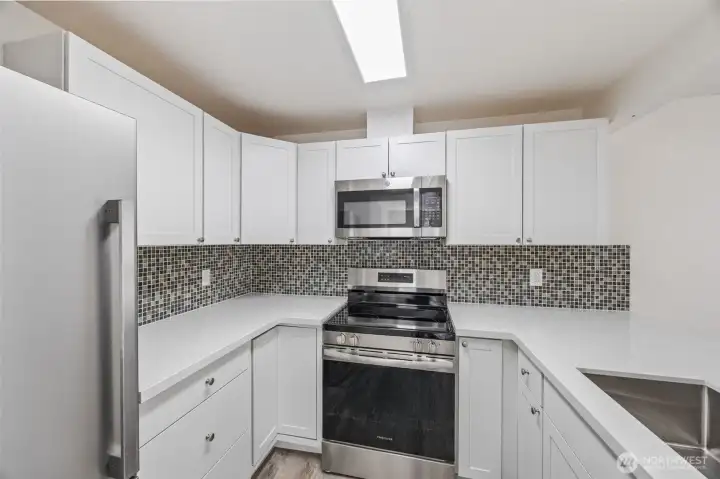 Sleek shaker cabinets, quartz counters, and brand-new SS appliances — move-in ready perfection.