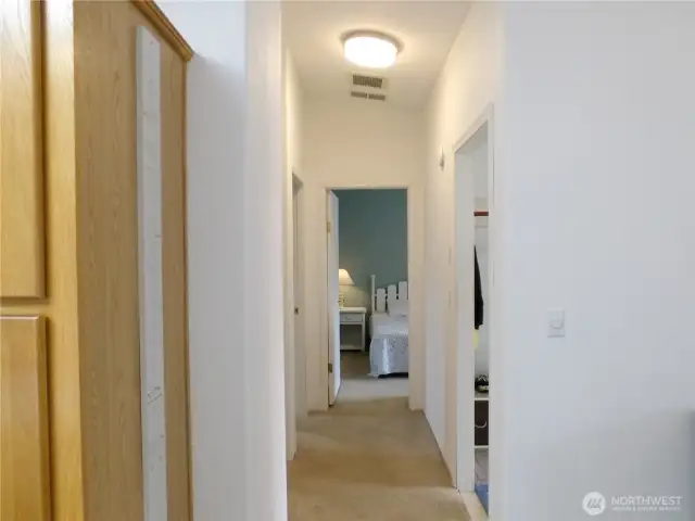 Hallway next to kitchen takes you to two additonal bedrooms, a full bathroom, and the laundry room.