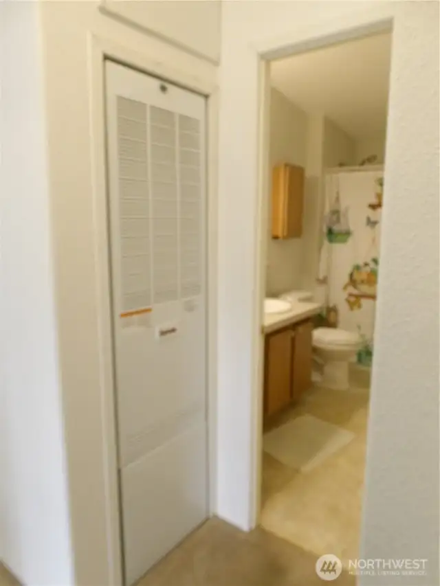 Bathroom entry in hallway at south side of the home.