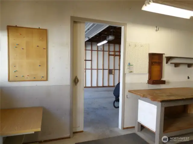 Pocket door from shop area that leads into the 2 car garage.