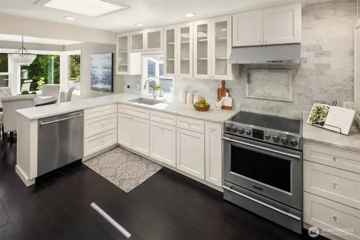 SS appliances, skylight, garden window, custom counter to cabinet backsplash make this kitchen a pleasure to work in.