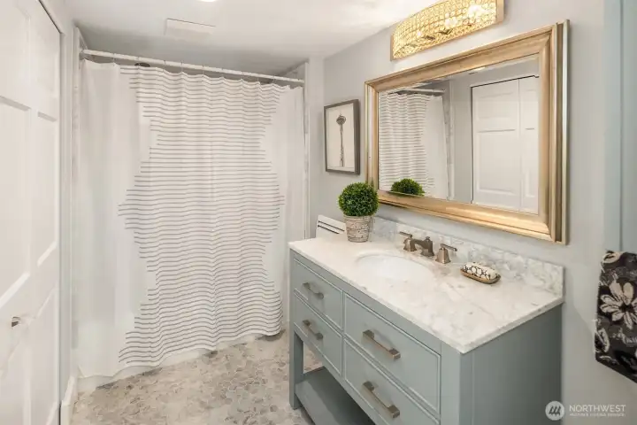Lower level bathroom with oversized closet for extra linen storage.