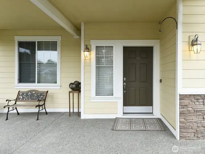 Hardi plank siding. Plenty room for patio furniture. Potted plants.