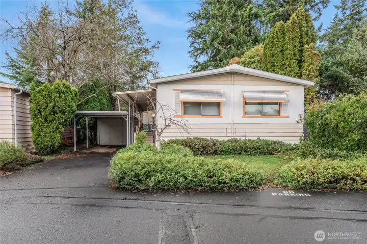 Front of home with beautiful trees surrounding