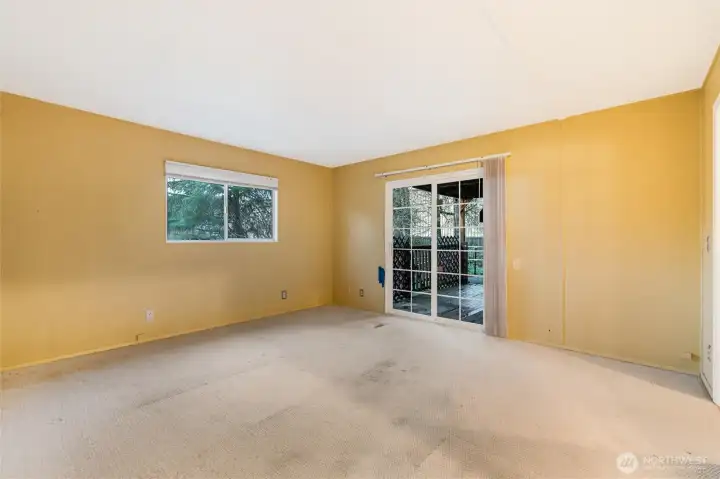 Primary bedroom with slder to back covered deck