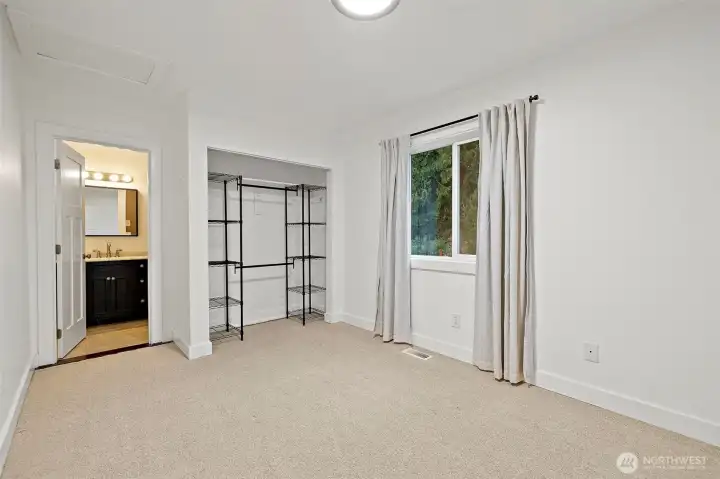 The primary bedroom with closet organizer, fresh new carpet and private full bathroom.