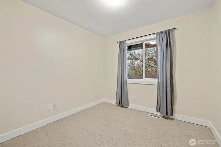 2nd bedroom at the front of the home with new carpet and fresh paint! Nice view!