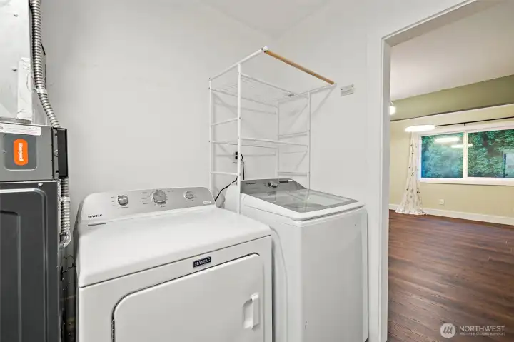 Laundry room off the dining room and also has an outside entry door from the driveway for convenient access. Washer and dryer stay!