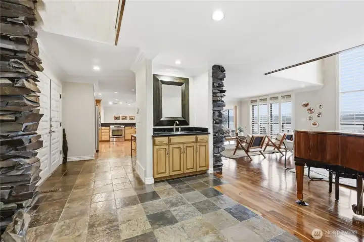Entryway, kitchen to the left, wetbar and living area to the right.