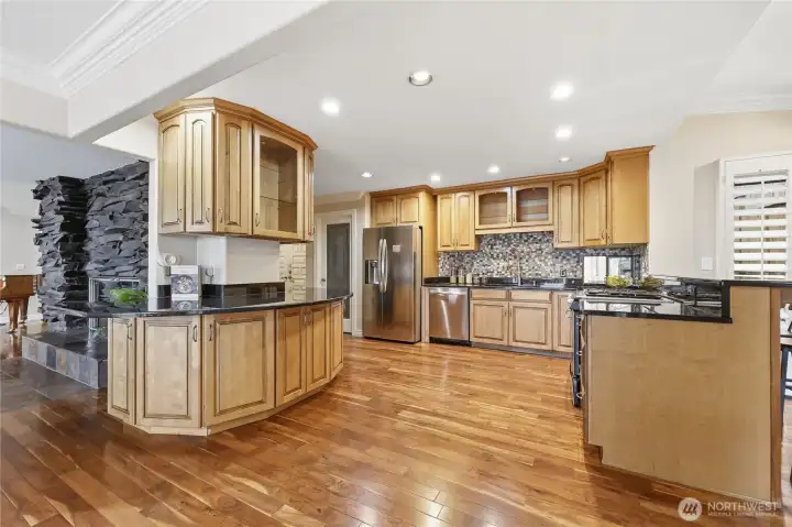 Kitchen with granite countertops and stainless steel appliances, custom tile backsplash and tons of storage!