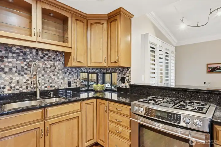 Lovely little window in the corner. Natural gas cooktop.