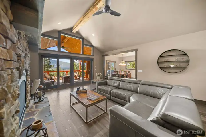 Gorgeous main room with vaulted ceilings, view, sliding glass doors to covered deck and gas fireplace