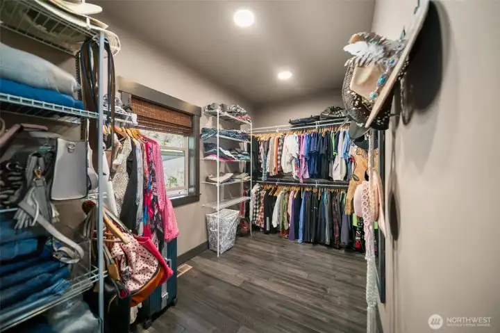 Large walk-in closet with lots of shelving