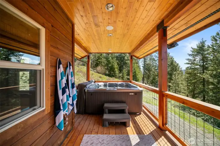 Private covered deck off Primary with hot tub, hot & cold water, beautiful views, wired for sound and TV