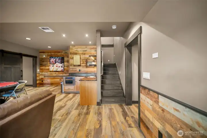 The daylight lower level is ideal for multi-generational living, guests, entertaining, or extended stays, featuring its own separate entrance, spacious rec room with kitchenette, wine cellar, second primary suite, and additional bedrooms