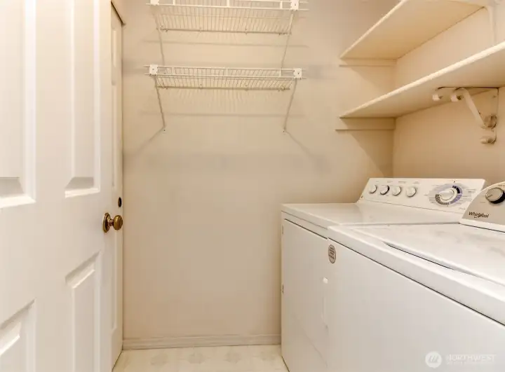 Main floor laundry room with storage