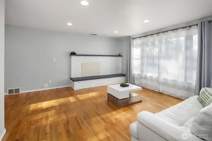 The main living room enjoys natural, SW facing light year round. Oak hardwood floors abound.