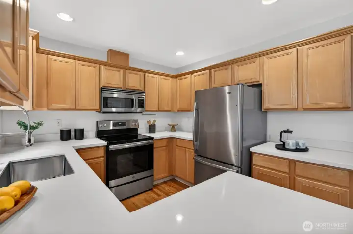 Large functionally in this bigger than average kitchen. Updated with stainless steel appliances and quartz slab counters. Lots of storage!