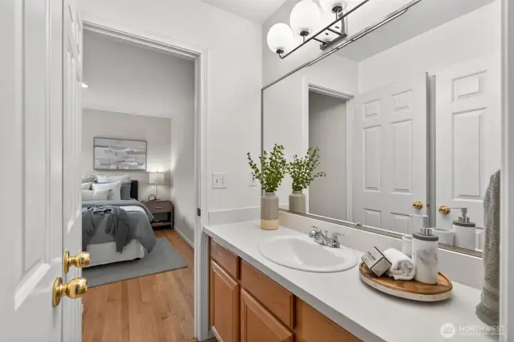 Shared en-suite bath with quartz countertops. Upstairs has 2 bedrooms & 1 bathroom plus full laundry room. Would be great as a whole Primary level too.