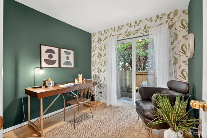 Garden-level bedroom with a walk-in closet to the left, bamboo floors, and access to private backyard. In entry hall is another closet for more storage.