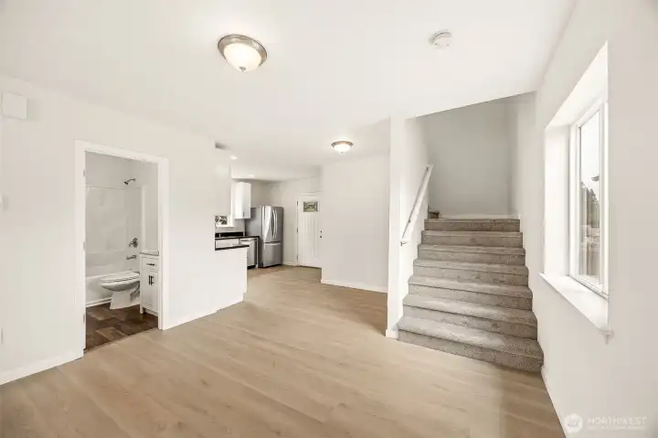 Main Floor Bath, Dining, Kitchen, and Access to Upper Level