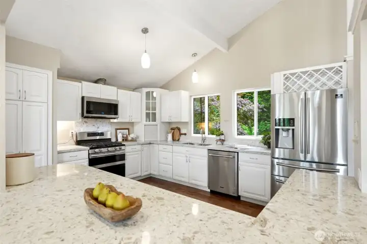 Bright and inviting kitchen with quartz countertops, stainless steel appliances, and seamless flow into the main living spaces Bright and inviting kitchen with quartz countertops, stainless steel appliances, and seamless flow into the main living spaces