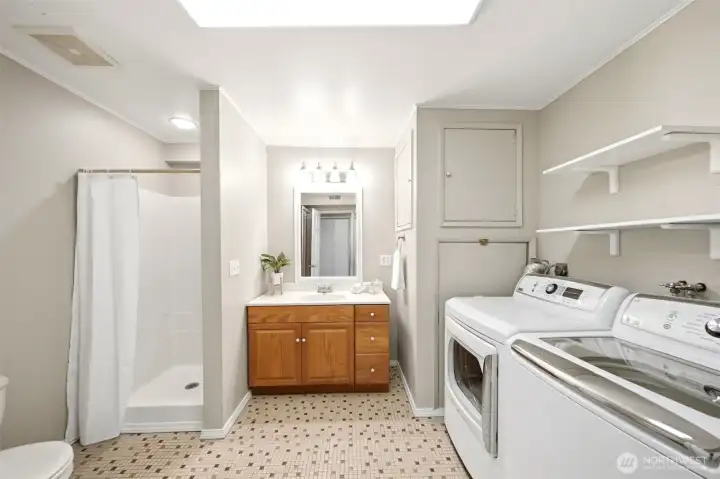 Spacious lower-level laundry room with additional bathroom, storage, and everyday convenience Spacious lower-level laundry room with additional bathroom, storage, and everyday convenience