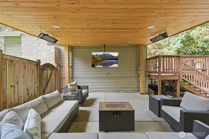 Year-round outdoor living featuring a covered entertaining space with heaters, built-in speakers, and room to gather Year-round outdoor living featuring a covered entertaining space with heaters, built-in speakers, and room to gather