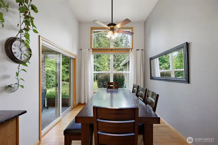 Extra large dining room with room for plenty of seating, sliding glass door and elevated ceilings.