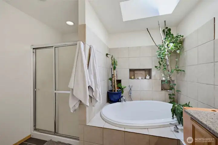 Oversized corner soaking tub with skylight above & walk-in shower complete this 5 piece bathroom.