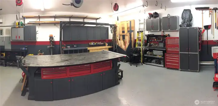 WOW just look at this garage! Epoxy floor, built in cabinet storage & plenty of room for all your toys!  240v 30A outlet for air compressor, multiple dedicated 20A outlets in garage for tools + every mans dream, a urinal in the garage.