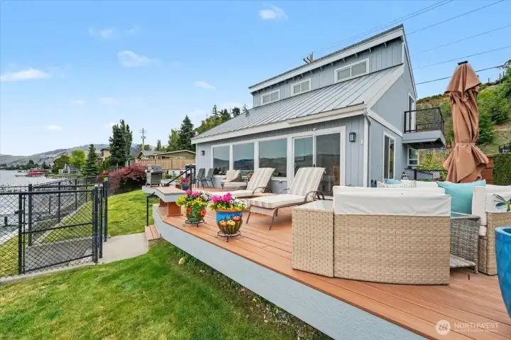 Featuring a pristine, newly completed deck that steps down to a fully secured, fenced lawn right on the water's edge.