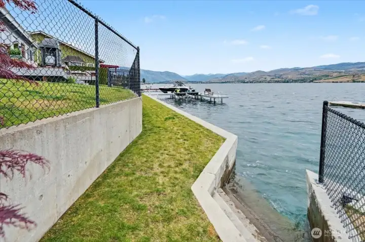 Newly constructed seawall with concrete steps on both sides providing seamless lake access.