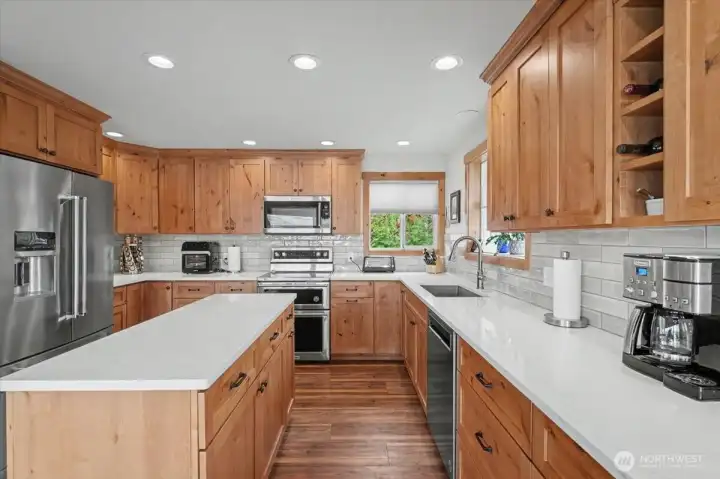 Completely remodeled kitchen showcasing pristine new wood cabinets.