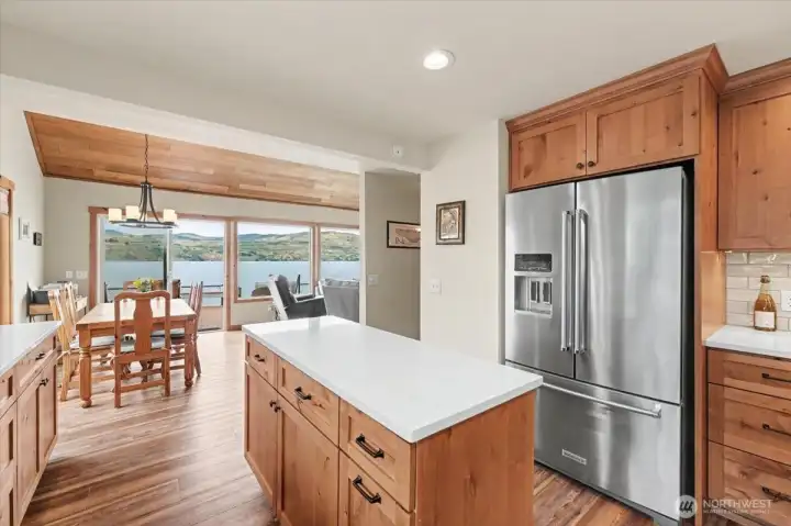 Open-concept layout offering a gorgeous, unobstructed view from the kitchen to the back deck and lake.