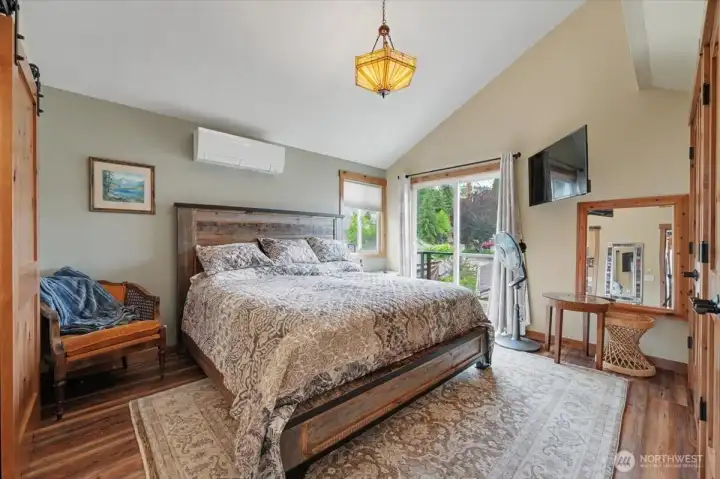 Primary bedroom featuring a private balcony—perfect for taking in starlit views of the lake at night.