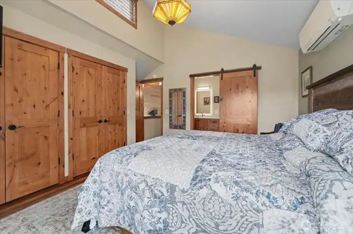 Primary bedroom complete with a newly updated barn door, attached bathroom, and massive closet space.