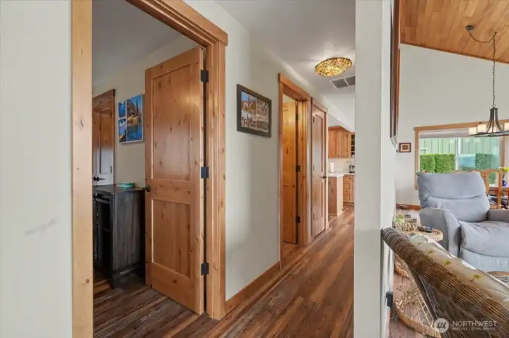 Beautifully updated hallway with pristine new wood floors and brand-new doors.