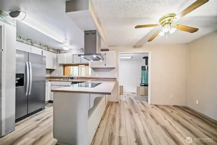 Kitchen features stainless steel appliances and a breakfast bar. Kitchen features stainless steel appliances and a breakfast bar.
