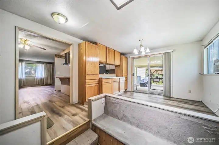 Dining room with pass through window from kitchen and buffet cabinets. Sitting area with pellet stove. Slider leads to your large deck with covered area. Dining room with pass through window from kitchen and buffet cabinets. Sitting area with pellet stove. Slider leads to your large deck with covered area.