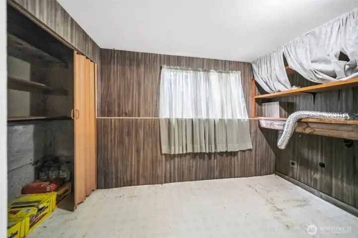 Large laundry room with a closet and built-in shelving. Large laundry room with a closet and built-in shelving.