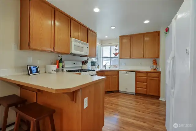 Super Clean Kitchen w/Pantry and White Appliances. Corner Windows & Recessed lighting keeps this room bright!